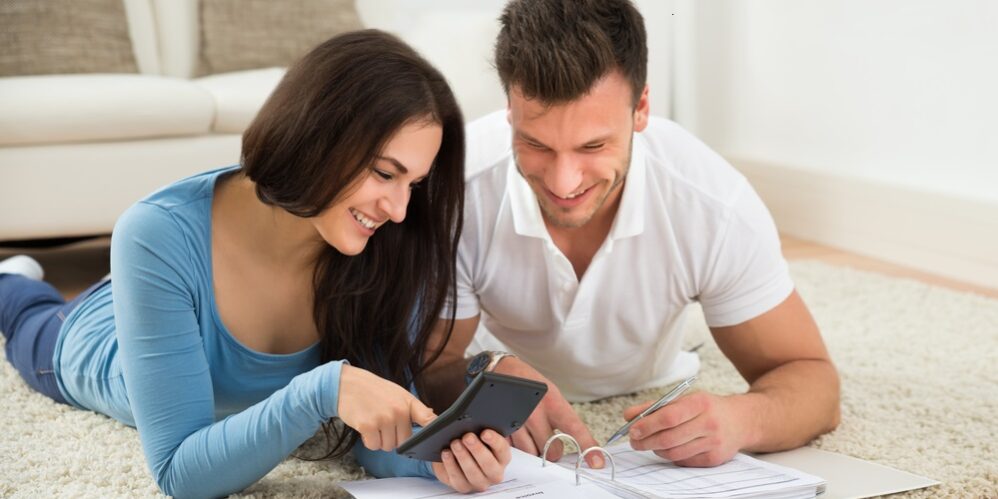 Happy Young Couple discussing financial goals