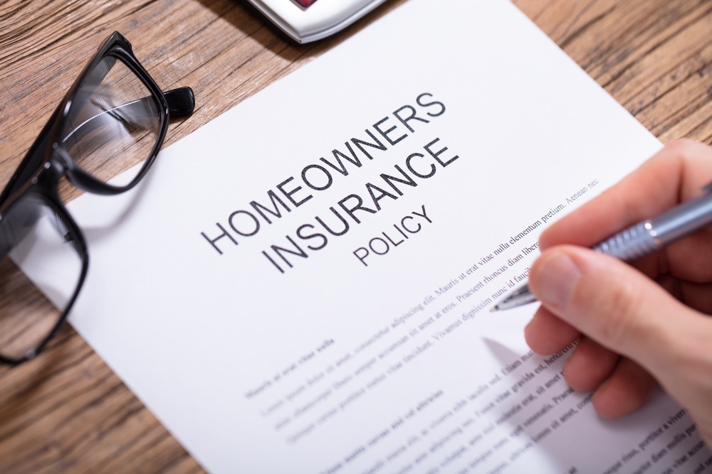 Person Filling Homeowners Insurance Policy Form
