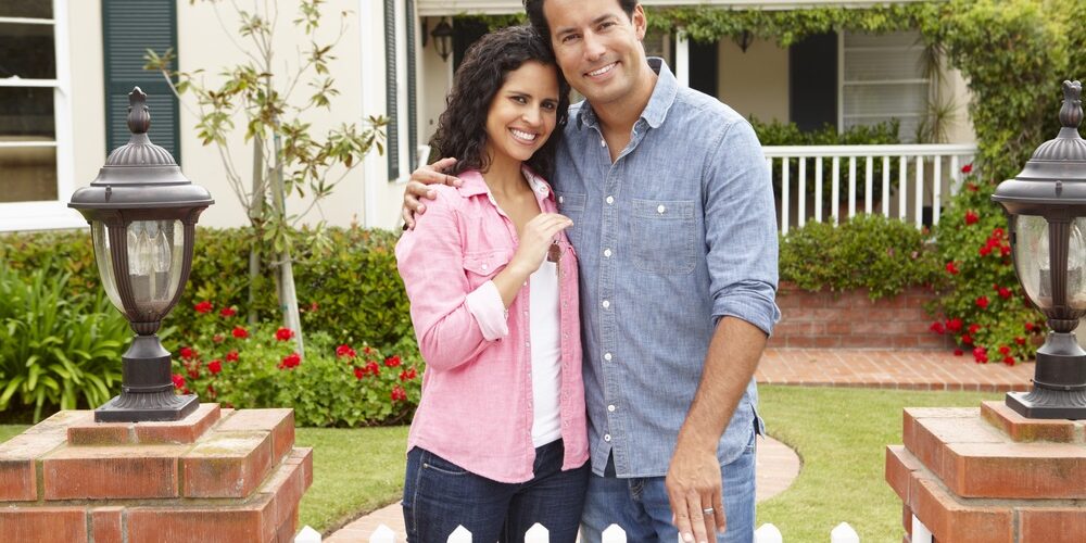 Homeowners Insurance Couple outside new home with homeowners insurance