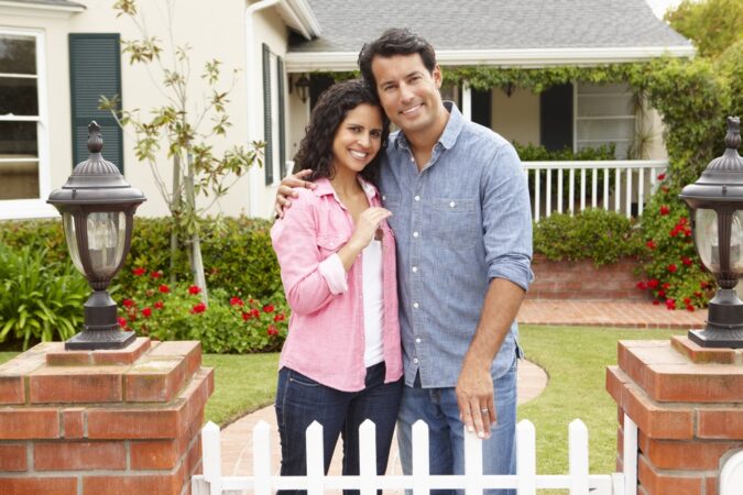 Homeowners Insurance Couple outside new home with homeowners insurance
