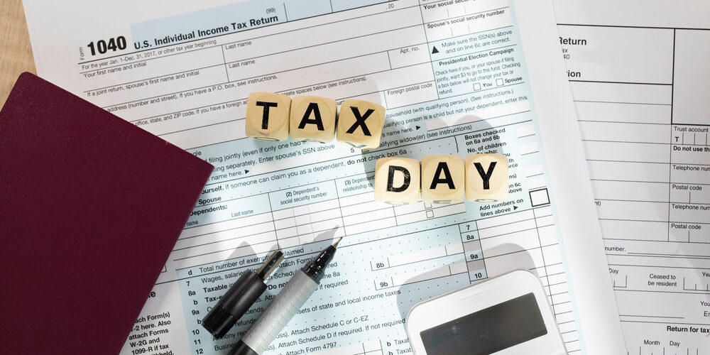 Word Tax Day composed of wooden letters. Closeup