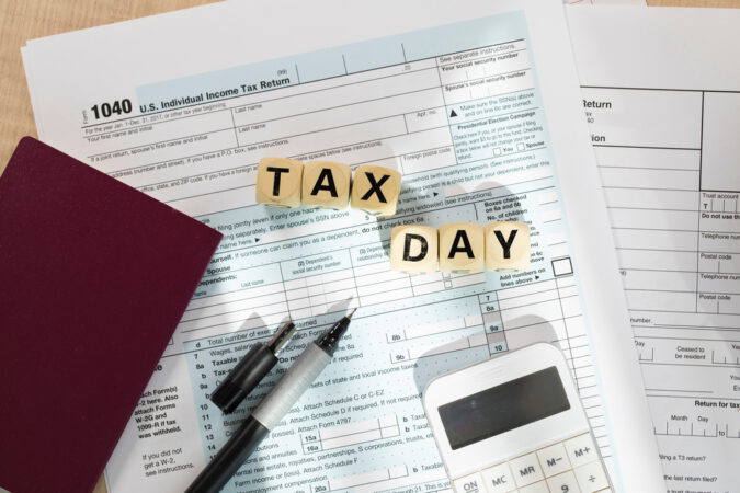 Word Tax Day composed of wooden letters. Closeup
